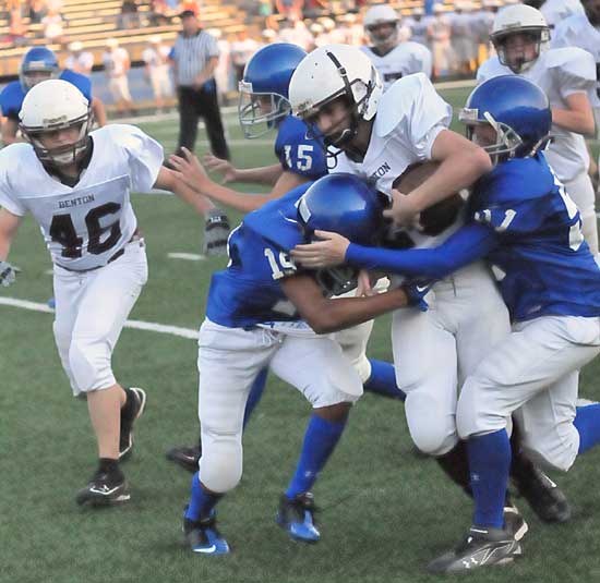 Trey Harris (19) and Ethan Henderson (51) make a tackle. (Photo by Kevin Nagle)