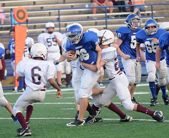 Bryant White's Hunter Montgomery gets hauled down as teammates including Damon Peters (66) come to his aid. (Photo by Kevin Nagle)