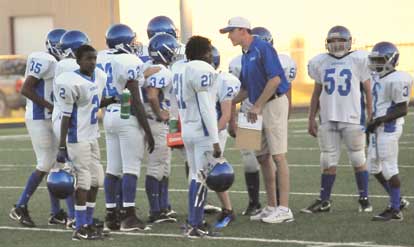 Bryant White coach Brad Smotherman huddles with his defense. (Photo by Kevin Nagle)