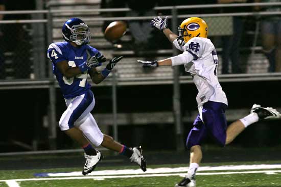 Brushawn Hunter (34) looks in a pass after getting behind Catholic's Burke Sanders. (Photo by Rick Nation)