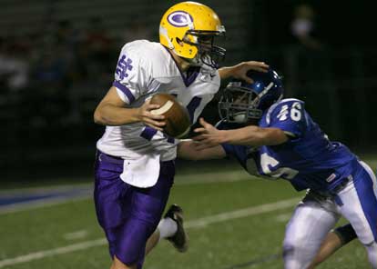 Kyle Lovelace (46) gets to Catholic quarterback Hayden Hum (Photo by Rick Nation)