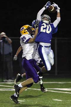 Drew Tipton (20) leaps for an interception. (Photo by Rick Nation)