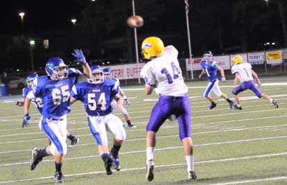 Tommy Wedge (65) and Drew Allen (54) put pressure on the quarterback. (Photo by Kevin Nagle)