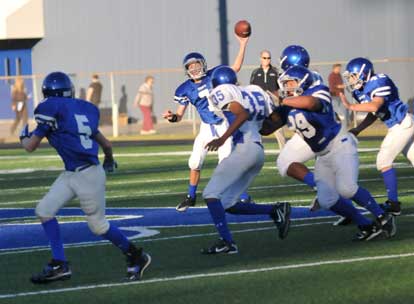 Evan Lee (7) fires a pass toward Liam Miller as J.P. Marrero (89) and Austin Fason (42) try to protect. (Photo by Kevin Nagle)