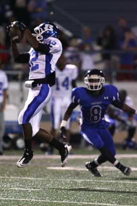 Charles Henson (12) comes down with a catch. (Photo by Rick Nation)