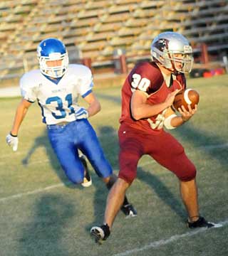 Bryant's Stoney Stevens (31) closes in on Benton's Shaun Carey. (Photo by Kevin Nagle)