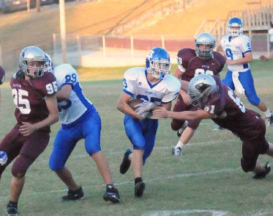 Sophomore tight end Kaleb Squires (89) blocks Benton's Trey Lester (95) as Jeffery Hodge (61) tries to get a hold on Bryant's running back. (Photo by Kevin Nagle)