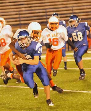 Hunter Lawhon (26) tries to break a tackle after breaking a run behind the block of Austin Fisher (58). (Photo by Kevin Nagle)