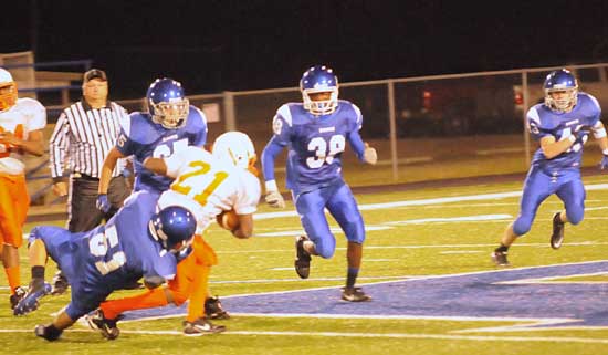 Bryant's Connor Chapdelaine hauls down a Little Rock Hall running back as teammates Jordan McDonald (38), Houston Chavis (25) and Brent Reeves (43) pursue. (Photo by Kevin Nagle)