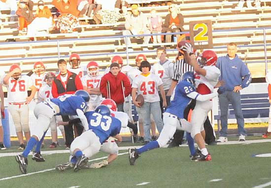 Kaliq Slater (23) smacks the Cabot North running back as he takes a pitch from his teammate who's being hit by Drew Alpe (33) and Kameron Guillory. (photo by Kevin Nagle)