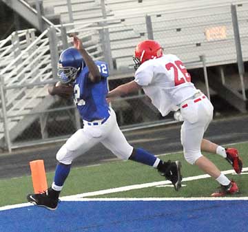 Demaja Price avoids a Cabot North tackler, Brody Lambert (26) on the Hornets' two-point conversion. (Photo by Kevin Nagle)