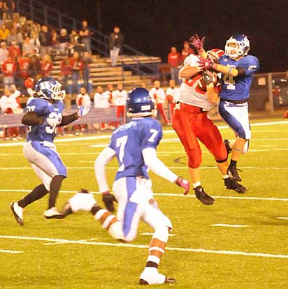 Bryant's Jessie Johnson (4) breaks up a pass intended for Keith Pledger as Tyree Reese (33) and Aaron Bell (7) close in. (Photo by Kevin Nagle)