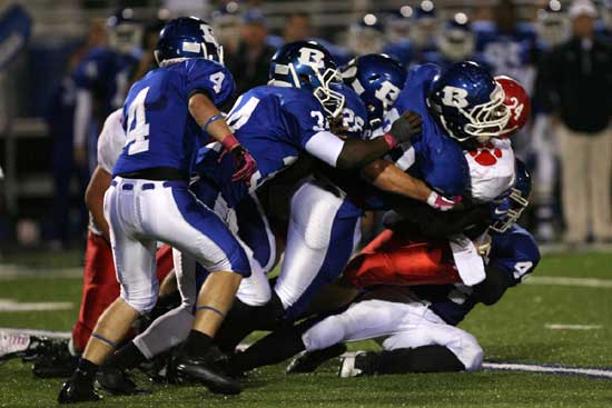 Cabot running back Zach Launius (24) is gang-tackles by Bryant's Tim Kelly (91), Marshall Everett (26), Walter Dunn (34), Jessie Johnson (4) and Jared Koon (44). (Photo by Rick Nation)