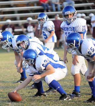 Gunnar Burks (13) prepares to take a snap from Drew Brown (63) with Ronnie Beard (55) and the rest of the offensive line primed to start the play. (Photo by Kevin Nagle)