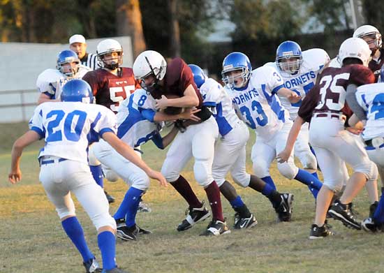 Daniel Darbonne (8) helps out on a tackle as temmates Josh Langston (33) and Tanner Austiin (20) among others close in to help. (Photo by Kevin Nagle)