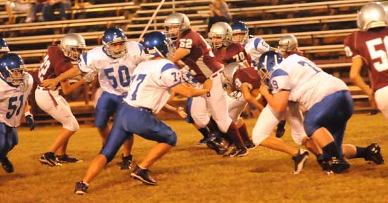 Christian Williams (79) makes a tackle as help arrives from Gavin Haas (77), Austin Vass (50) and Conner Chapdelaine (51). (Photo by Kevin Nagle)
