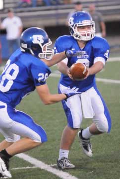 Quarterback Wesley Akers (9) hands off to Davis Nossaman (28). (Photo by Kevin Nagle)