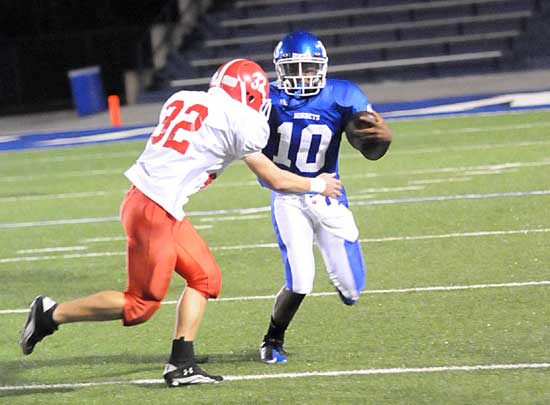 Davonte Howard (10) tries to evade a Cabot tackler. (Photo by Kevin Nagle)