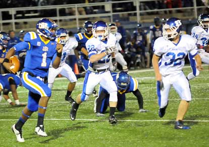 Bryant's Jacob Powell (22) and Parker Dunn (32) try to hem in North Little Rock quarterback Kaylon Cooper. (Photo by Kevin Nagle)