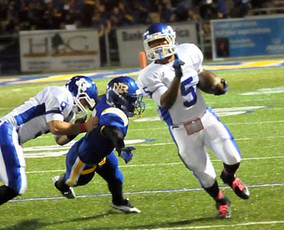 Bryant's Karon Dismuke (5) turns upfield off a block by Wesley Akers (9). (Photo by Kevin Nagle)