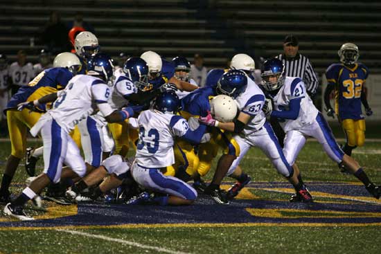 Ryan Hall (53), Brendan Young (33), Ben Bruick (21), Austin Trusty (52) and K.J. Hill (6) swarm around a North Little Rock ball carrier. (Photo by Rick Nation)