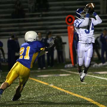 Brushawn Hunter (34) grabs a pass in front of North Little Rock's Heath Land (21). (Photo by Rick Nation)