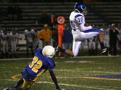 Steven Murdock makes a leaping catch in front of North Little Rock's Danny Mitchell. (Photo by Rick Nation)