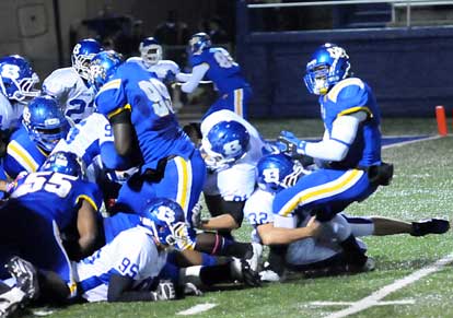 Bryant's defense knocks the ball away from tailback Juan Day. Unfortunately for Bryant, quarterback Kaylon Cooper scooped up the loose ball and turned it into a touchdown. (Photo by Kevin Nagle)