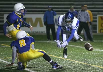 Bryant's Drew Tipton (20) blocks an extra point attempt. (Photo by Rick Nation)