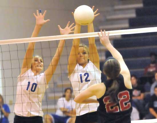 Alyssa Anderson (10) and McKenzie Ricke (12) go up for a block. (Photo by Kevin Nagle)