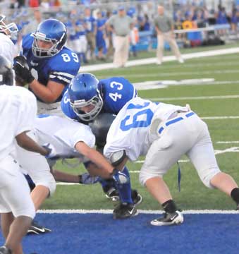 Peyton Robertson (43) powers into the end zone off a block by J.P. Marrero (89).