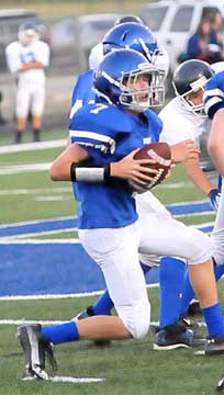 Quarterback Evan Lee looks downfield before a rollout. (Photo by Kevin Nagle)