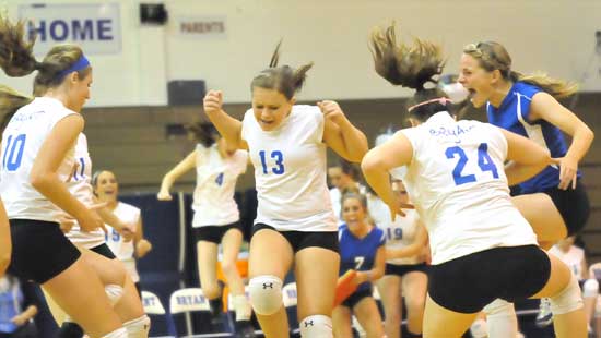 Alyssa Anderson (10), Taylor West (13), Lauren Reed and Brooke Howell (24) celebrate a point. (Photo by Kevin Nagle)