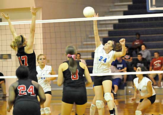 Brooke Howell (24) spikes the ball. (Photo by Kevin Nagle)