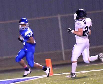 Brushawn Hunter reaches the goal line on his 69-yard punt return as Conway White's Collin Condit (20) trails the play. (Photo by Kevin Nagle)