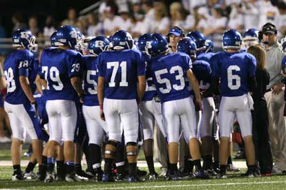 Head coach Paul Calley and assistant Jason Hay instruct the offense during a timeout. (Photo by Rick Nation)