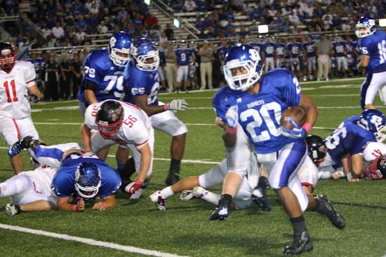 Junior running back Jalen Bell heads upfield off blocks by Blain Jackson (71) and Marshall Everett (26) as Jordan Jones (79) and Kordell Boykins (65) trail the play. (Photo by Rick Nation)