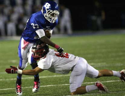 Travis Royal (23) tries to fend off a tackle by Russellville's Frank Chiolino after an interception. (Photo by Rick Nation)