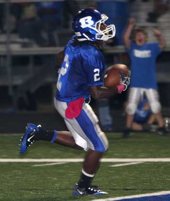 Dillon Winfrey scores after his interception as a fan in the background joins in the cheers. (Photo by Rick Nation)