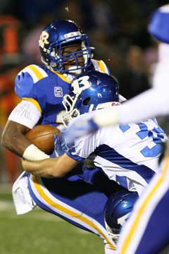 Parker Dunn (32) makes a tackle. (Photo by Rick Nation)