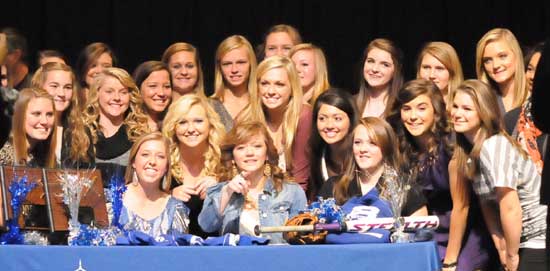 Kayla Sory, Peyton Jenkins and Jessie Taylor are surrounded by their teammates after their signing ceremony Thursday. (Photo by Kevin Nagle)