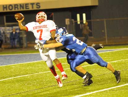 Bryant's Jacob Powell (22) and a teammate hit Northside quarterback Kenrick Burns. (Photo by Kevin Nagle)