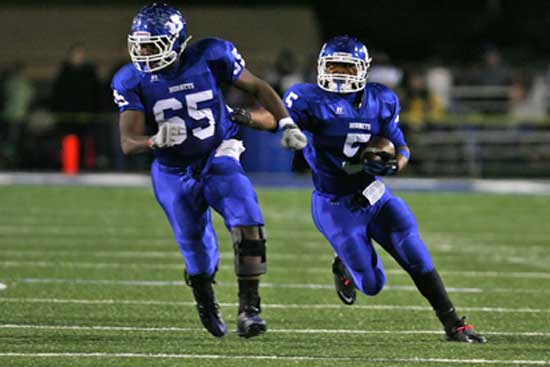 Karon Dismuke (5) follows the blocking of Kordell Boykins. (Photo by Rick Nation)