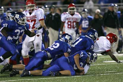 Tim Kelly (91), Parker Dunn (32) and Jacob Powell (22) bring down Northside's Donny Jones as linebacker Tyree Reese (33) closes in to help. (Photo by Rick Nation)