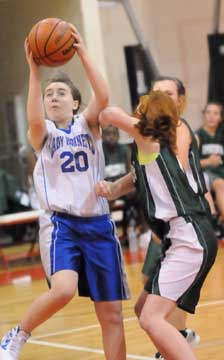 Jordan McKnight (20) goes up for a shot. (Photo by Kevin Nagle)