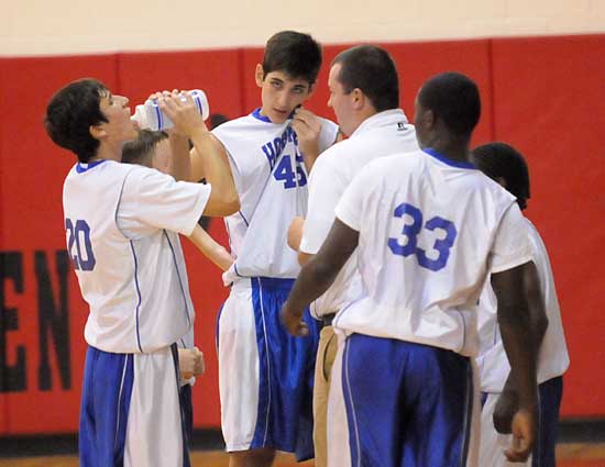 Bryant White coach Heath Long instructs his team during a timeout. (Photo by Kevin Nagle)