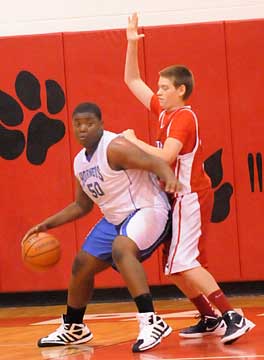 Cameron Murray posts up an Arkansas Baptist player. (Photo by Kevin Nagle)