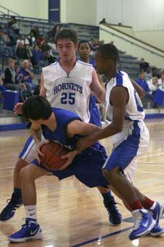 Ryan Hall (25) and Brushawn Hunter (00) work a trap in the backcourt. (Photo by Rick Nation)