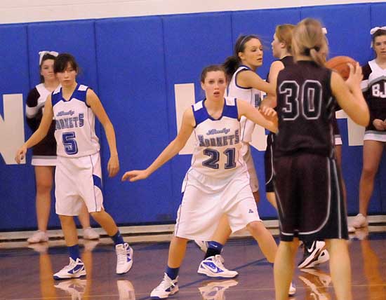 Bryant's Destiny Huffman (5), Taylor Lindberg (21) and Katie Davidson defend against Benton Thursday. (Photo by Kevin Nagle)