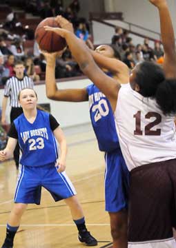 Faith Brown (20) tries to get a shot away in front of teammate Skylar Davis (23). (Photo by Kevin Nagle)